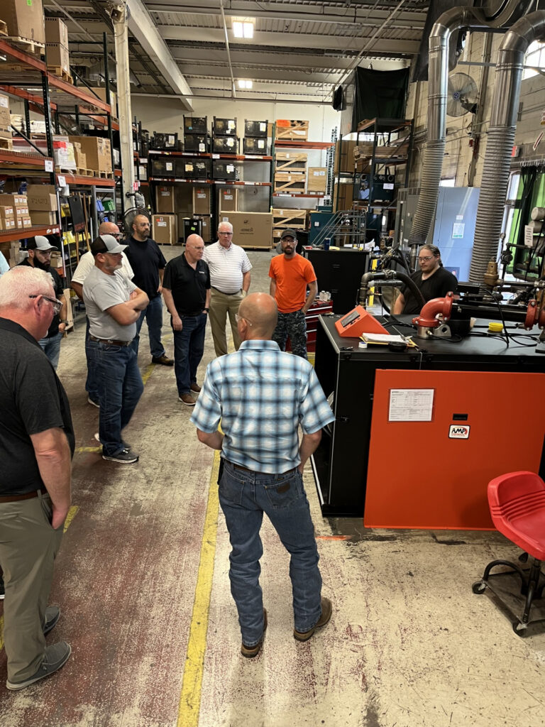 people standing around a boiler for Thermal Solutions service school training